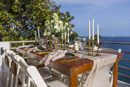 White and Gold Romantic Wedding Table Top Layout Table Spread no people no human tropical location with gold cutlery and scenic view tablescape