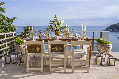 White and Gold Romantic Wedding Table Top Layout Table Spread no people no human tropical location with gold cutlery and scenic view tablescape © Huw Penson