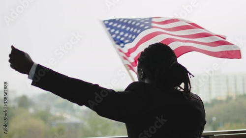 Black americian president dream again waving flag with pride photo