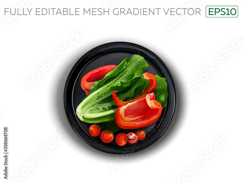 Bell pepper, lettuce and cherry tomatoes on a black plate.