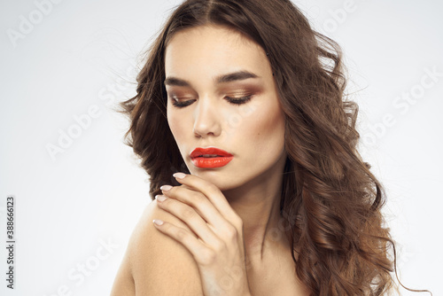 Beautiful woman with drawn swords bright makeup glamor close-up light background