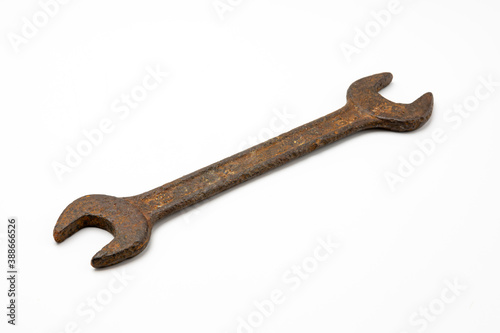 Old and rusty wrench on white isolated background