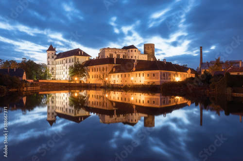 Jindrichuv Hradec Castle by night. Reflection in the water. Czech Republic. Most popular place in town. Calm water on pond. © Michal