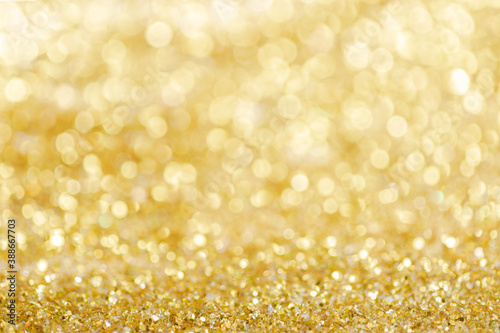 Gold light Festive Christmas background. Abstract twinkled bright background with bokeh defocused golden lights © kaewphoto