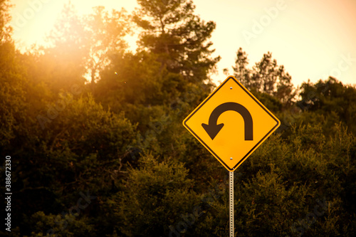 Traffic sign in yellow and black for a hairpin turn