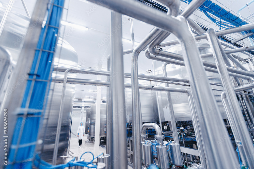 Operator female in uniform uses control panel manage process dairy plant food factory production line Operator female in uniform uses control panel manage process dairy plant food factory production line