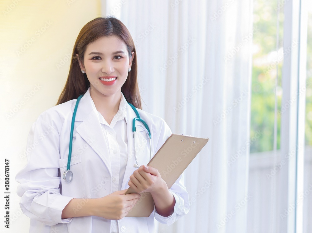 Asian female doctor standing wearing a white robe and stethoscope,interview sheet Asian female doctor standing wearing a white robe and stethoscope,interview sheet