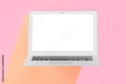 Modern laptop on color background