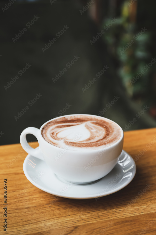 Cup of tasty cappuccino on table in cafe Cup of tasty cappuccino on table in cafe