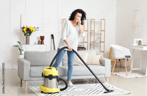 Allergic woman cleaning her flat