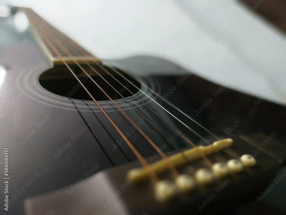 Fototapeta premium Close-up guitar body with sound hole and strings.blur photo