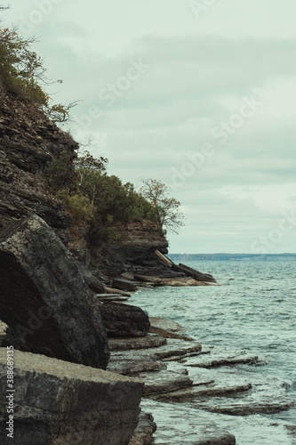 sheer cliff edge with trees and water around