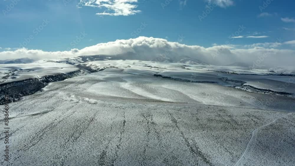 Time lapse drone shot of forward tracking plain, with passing clouds