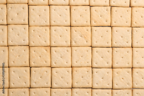 Many delicious crackers as background  top view