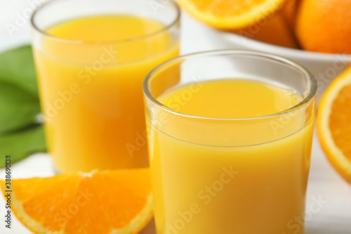 Glasses of delicious fresh orange juice, closeup