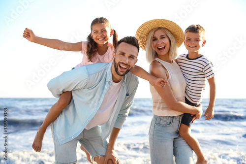 Photography Happy family on beach near sea. Summer vacation