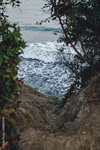 descent to the sea, cliff, waves on the beach