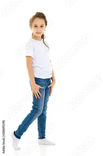 Pretty Stylish Girl with Ponytail Standing with Hands on Her Waist.