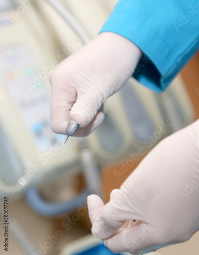 close up of a doctor holding a dental turbine