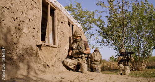 Fotografie Reconnaissance squad collecting data near aged cabin