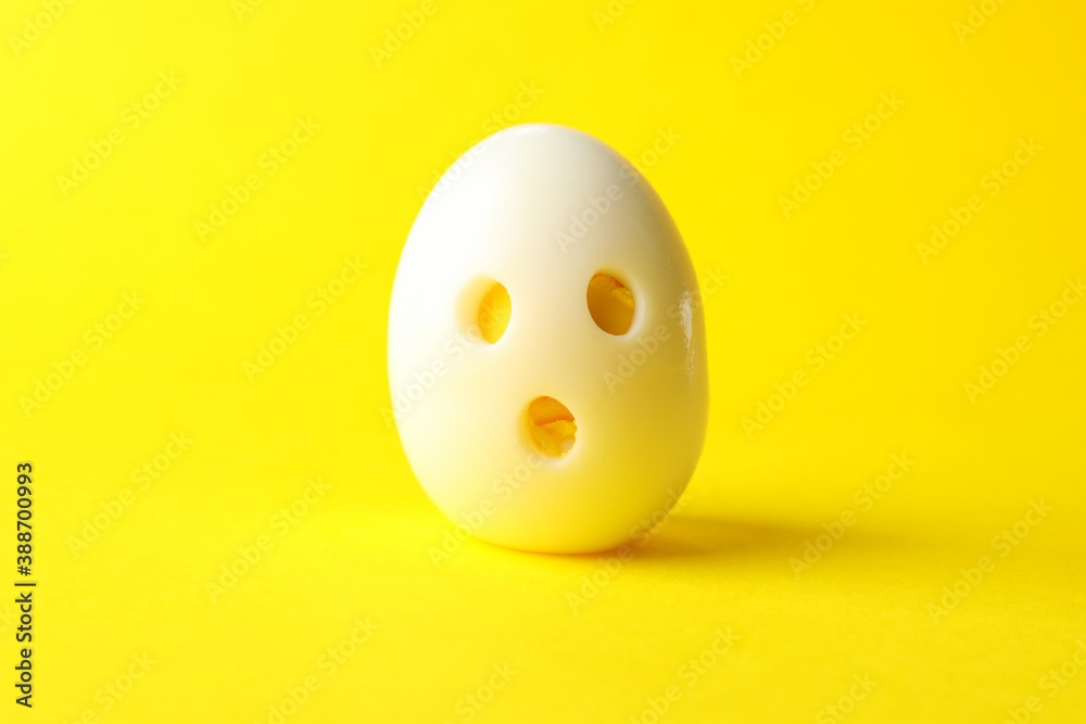 Fototapeta premium Hard boiled egg on yellow background, close up