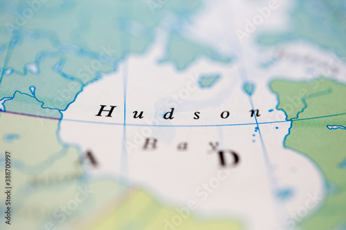 Shallow depth of field focus on geographical map location of Hudson Bay off coast of Canada on atlas photo