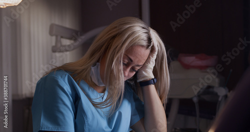 Tablou pe pânză Tired female dentist finishing work day