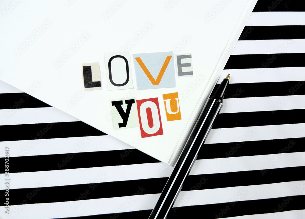 Love you - cut paper letter , declaration of love, combination of red black white colors, striped background Love you - cut paper letter , declaration of love, combination of red black white colors, striped background