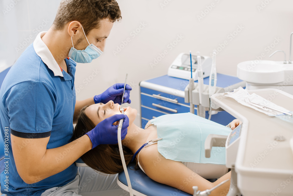 A dentist working with patient with dental drill A dentist working with patient with dental drill