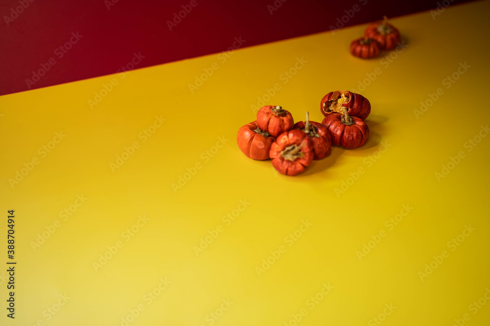 Group of little pumpkins over yellow surface