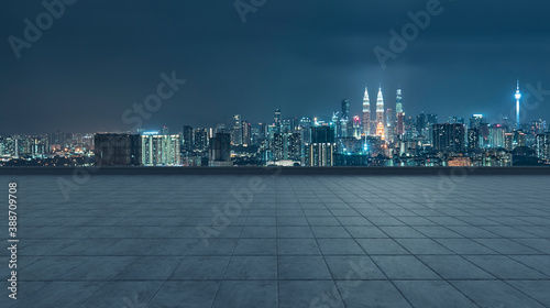 Empty concrete tiles floor with city skyline background