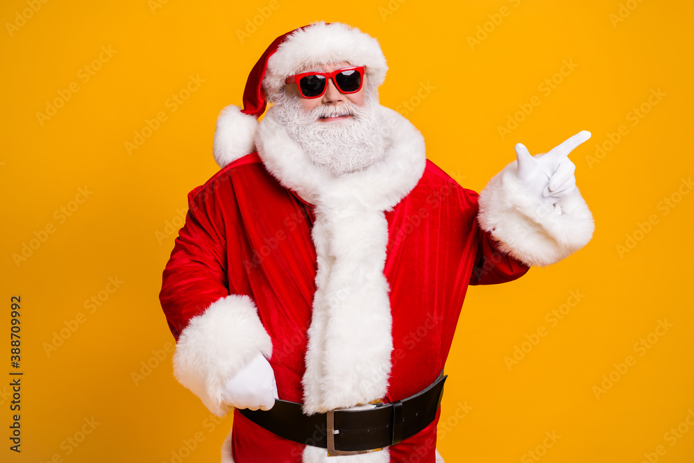 Portrait of his he nice attractive cheerful cheery fat Santa father demonstrating copy space advert newyear celebratory day isolated over bright vivid shine vibrant yellow color background - obrazy, fototapety, plakaty 