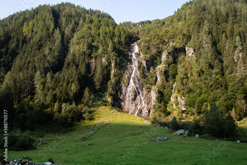 Beautiful landscape in the Habach Valley with mountains and a small waterfall in the morning sun photo