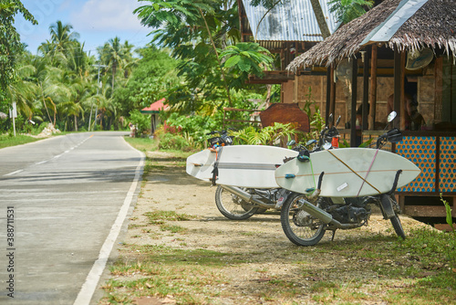 Two motorbikes carrying surf boards in Siargao island
