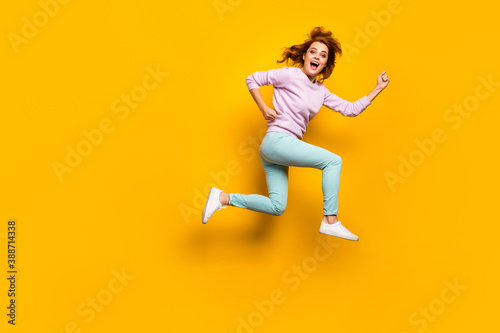 Full size profile side photo of cheerful crazy woman jump run after fall black friday discount wear casual style clothing isolated over shine color background