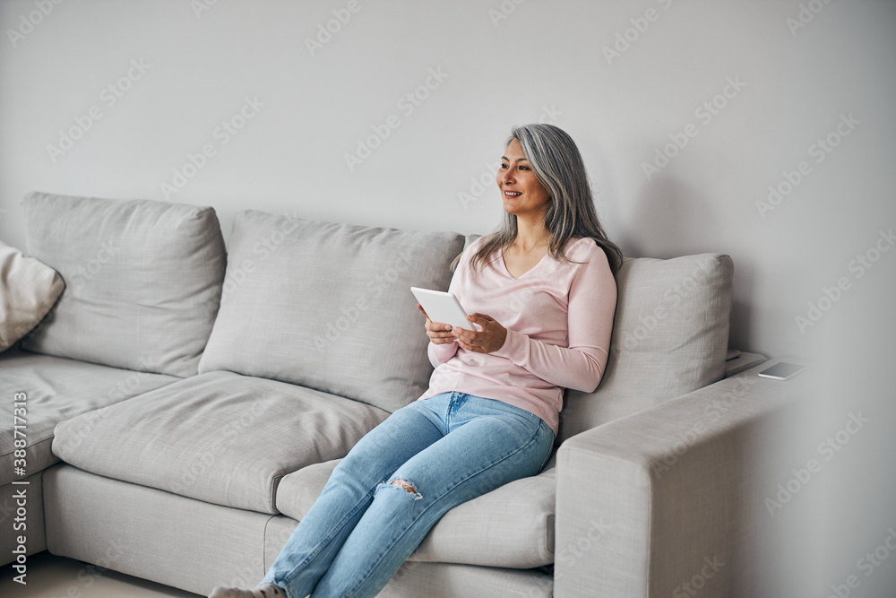 Charming elegant female laughing and resting at home Charming elegant female laughing and resting at home