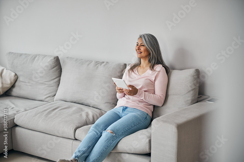 Charming elegant female laughing and resting at home