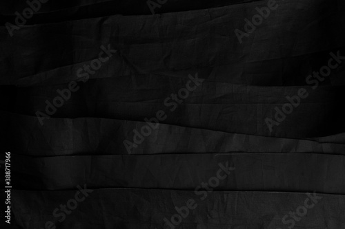 Black wrinkled stripes of synthetic material