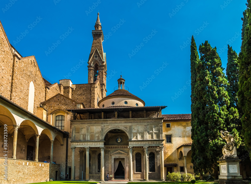 Gorgeous close-up view of the Pazzi Chapel in the cloister of the Basilica di Santa Croce in Florence, Italy. It has an arched portal topped by a loggia with decorative elements as a grand entryway.