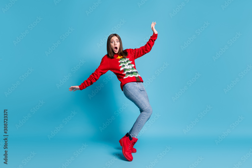 Full length photo of lovely pretty lady stand tiptoes raise hands falling open mouth staring terrified horrified mad look wear red sweater jeans boots isolated blue color background