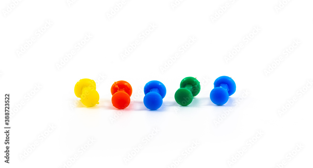 Several multicolored pins, macro photo on white isolated background