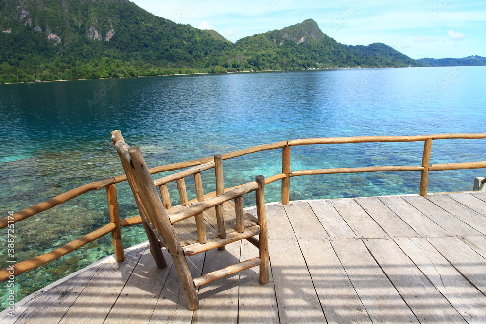 The chair on the dock with view to the  sea at Ora Beach Resort, Central Maluku, Indonesia
