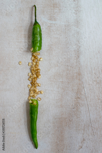 green chili peppers on wooden background