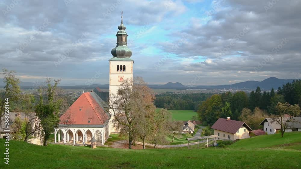 Annunciation catholic church and flatland basin in the background. Autumn season in Slovenia. Wide angle, left pan Annunciation catholic church and flatland basin in the background. Autumn season in Slovenia. Wide angle, left pan
