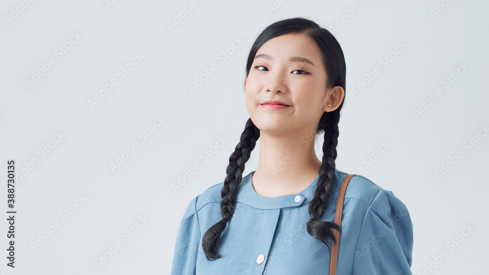 Portrait of a pretty girl holding backpack and looking at camera isolated over white background Portrait of a pretty girl holding backpack and looking at camera isolated over white background