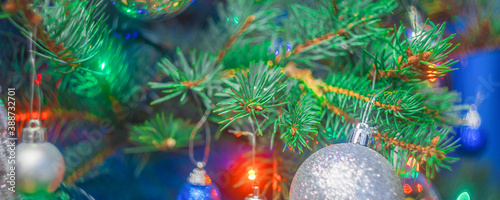Bright christmas tree with decorations and colorful lights, soft focus blurry background