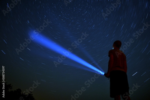 Person in the night space holding flashlight