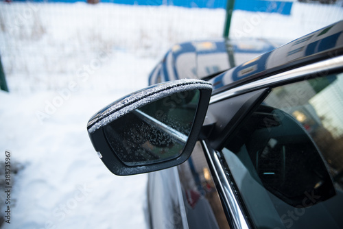 Frozen car, frozen mirror and side window, side view, winter, snow, ice