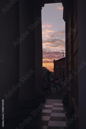 Sunset orange and pink sky  columns  architecture and city  buildings  people