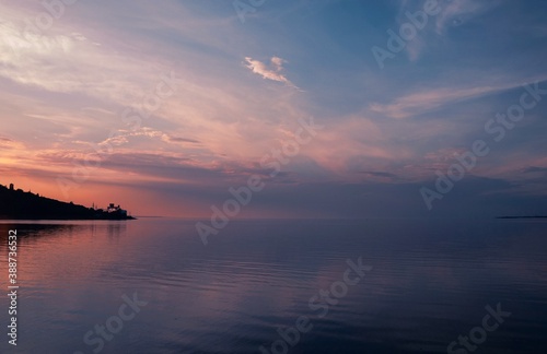 Amazing sunset orange and blue sky over the sea, beautiful colours of sunset  © Евгенія Борунова